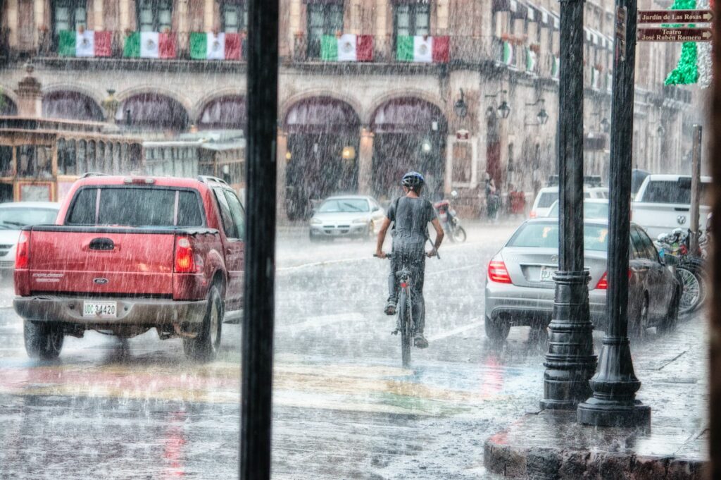 Weather Alert person riding a bicycle during rainy day